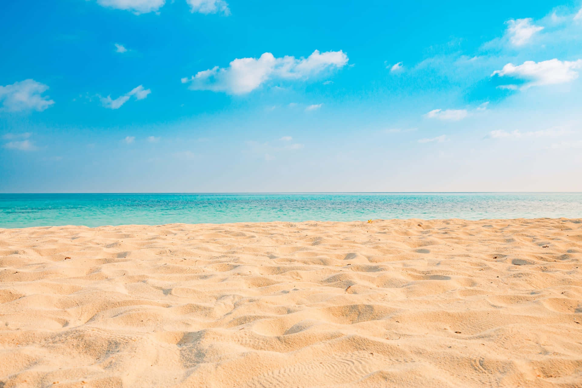 An empty beach with sand and blue sea - Sand