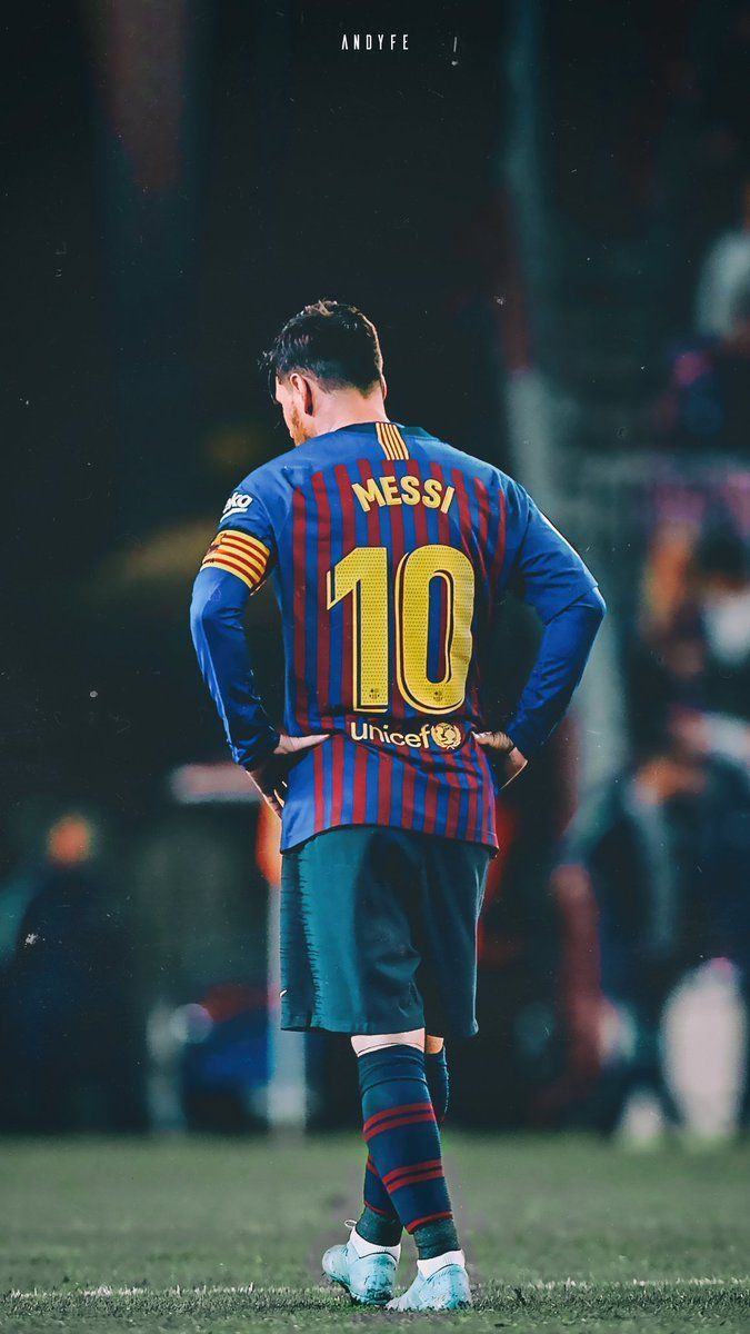 Lionel Messi standing on the field with his hands on his hips - Messi