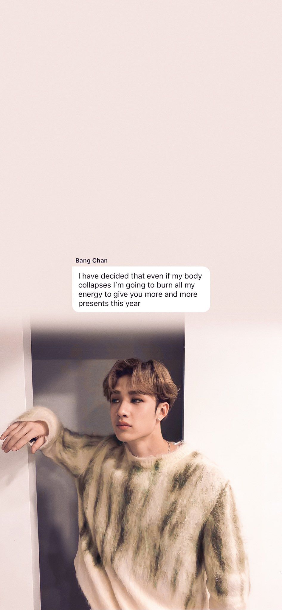 This is a photo of a person leaning against a wall. - Bang Chan