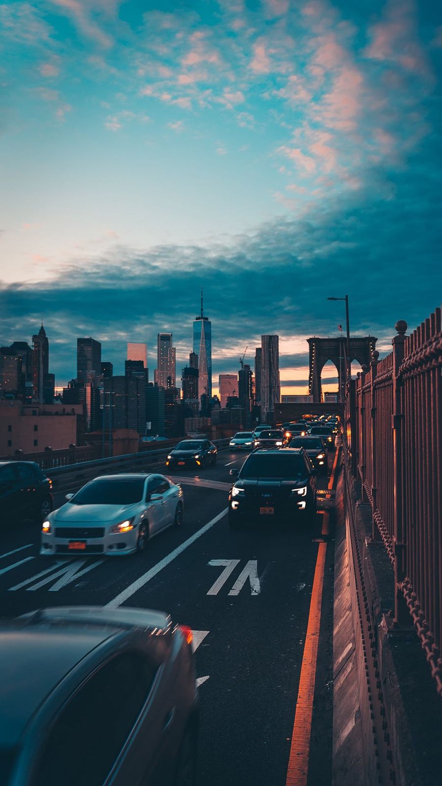 Cars on a bridge with a city skyline in the background - New York