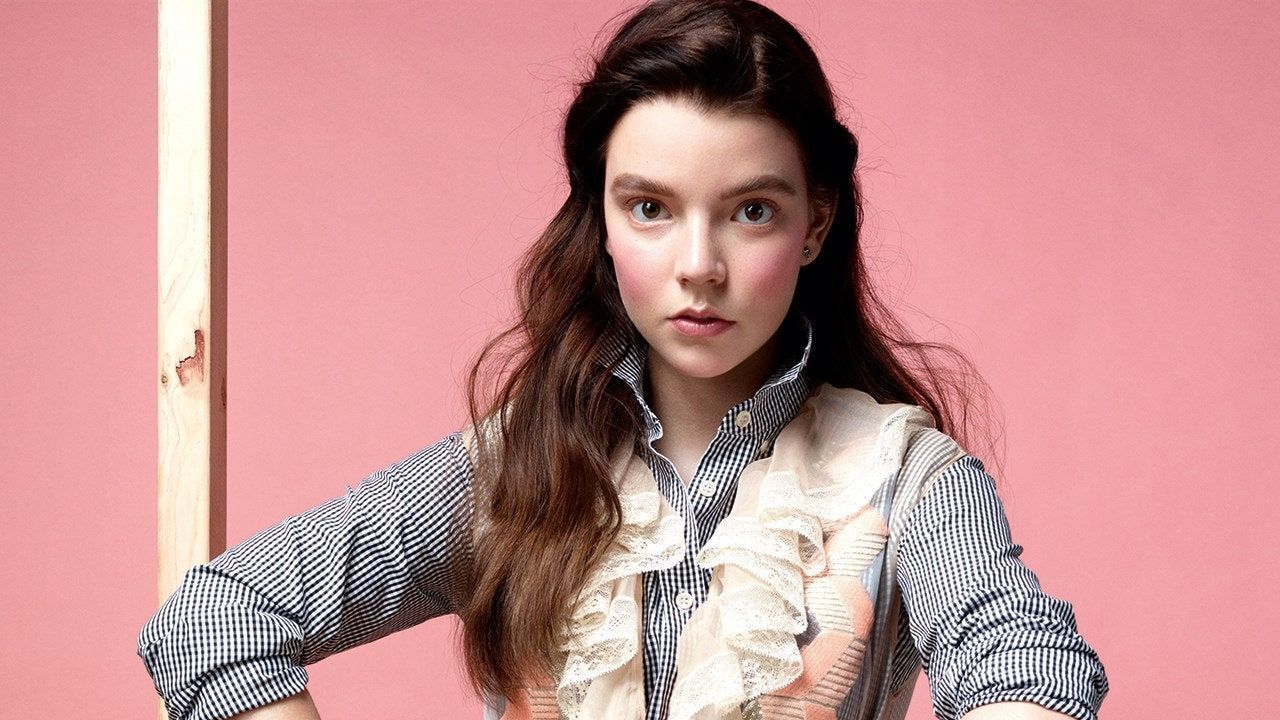 A woman with long brown hair and a white shirt with a bow on it. - Anya Taylor-Joy