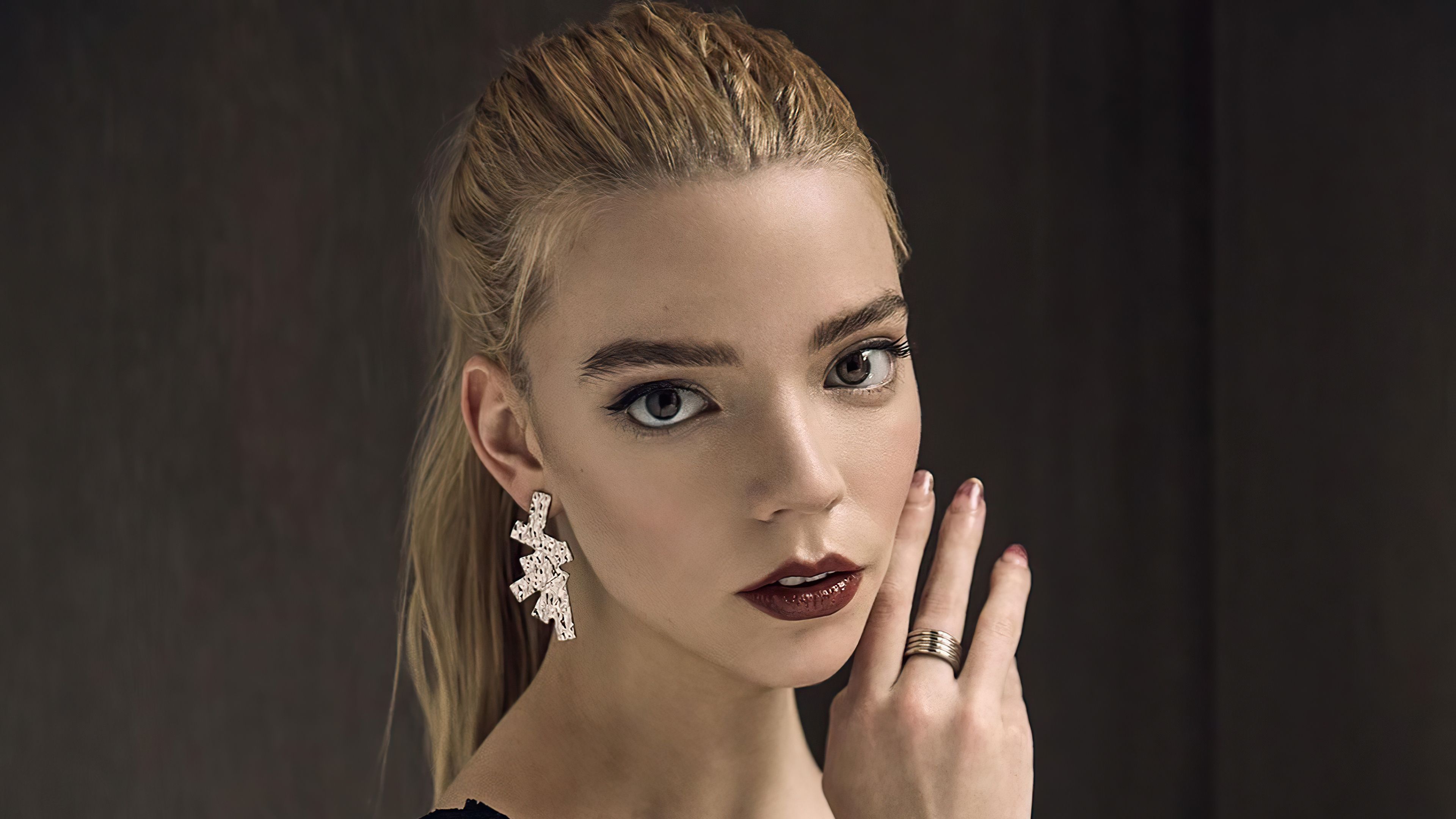 A model with blonde hair and a dark lipstick poses for a picture. - Anya Taylor-Joy