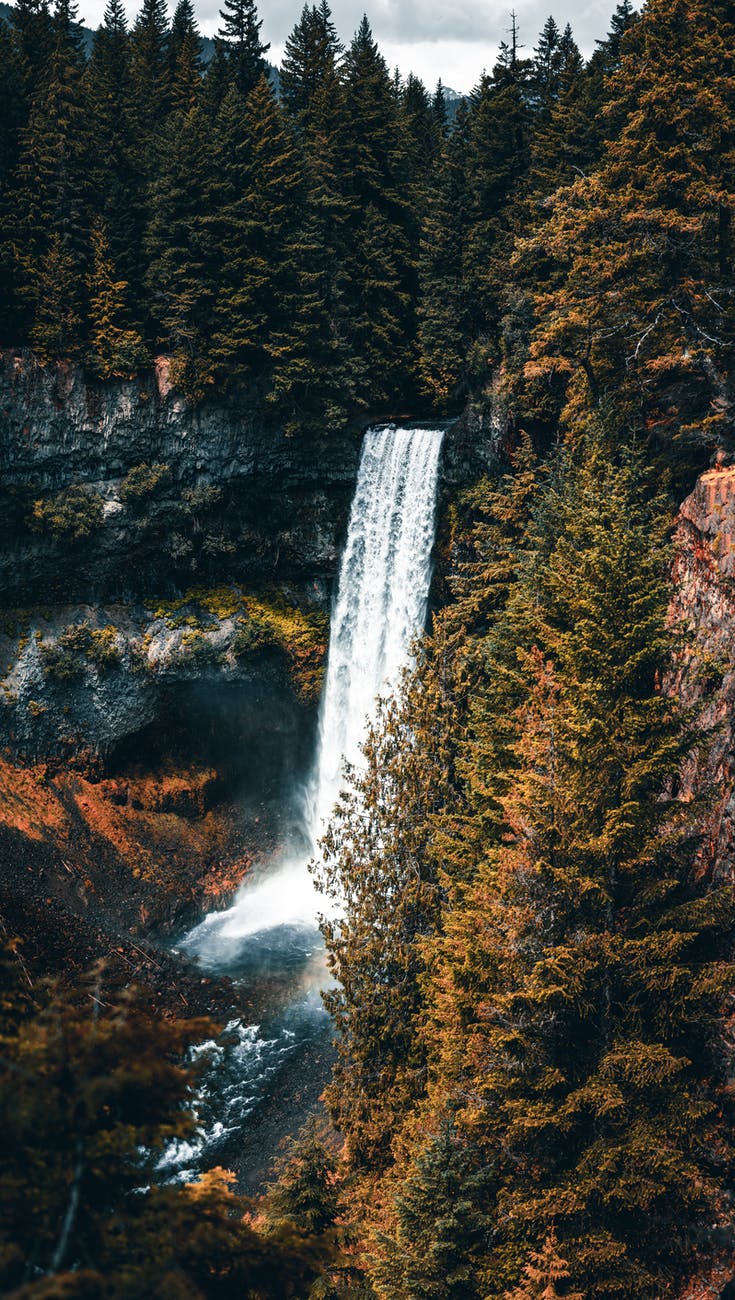 foaming waterfall streaming through rocky cliff