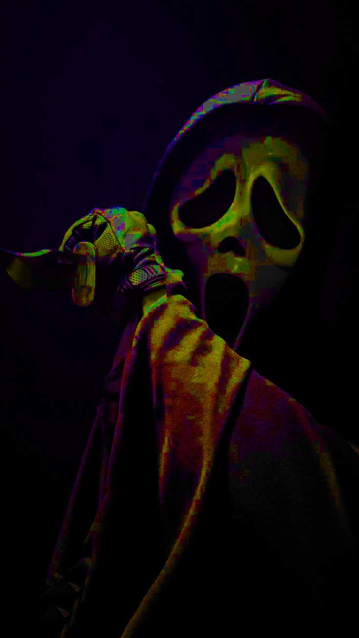 A man wearing a hooded jacket with a skull face mask on his face. - Ghostface