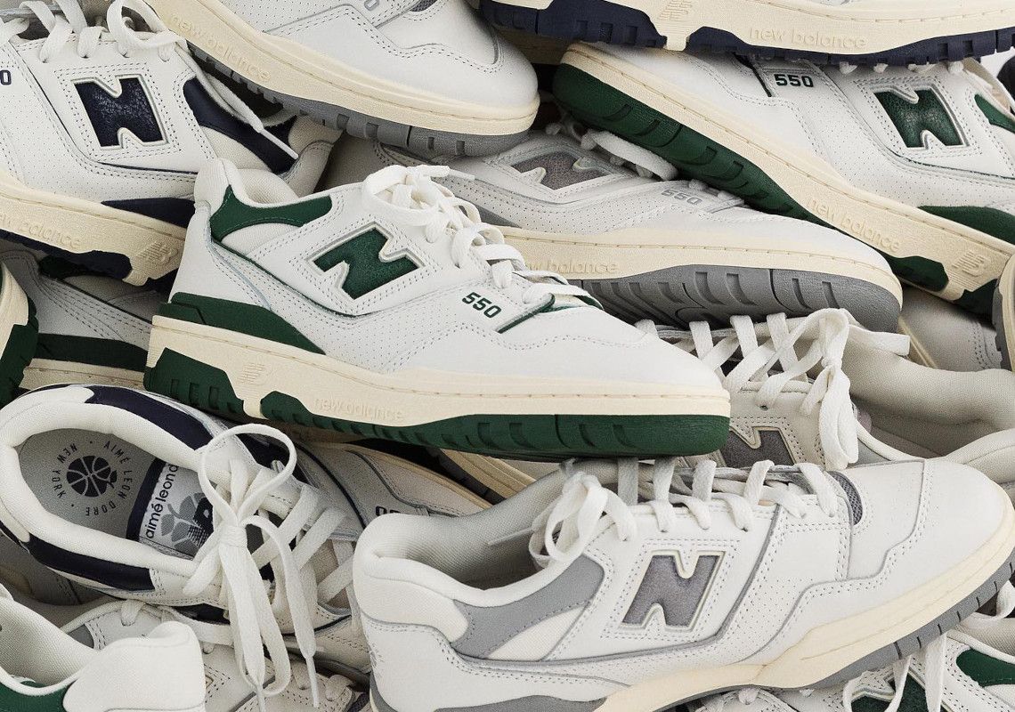 A pile of white and green New Balance sneakers. - New Balance