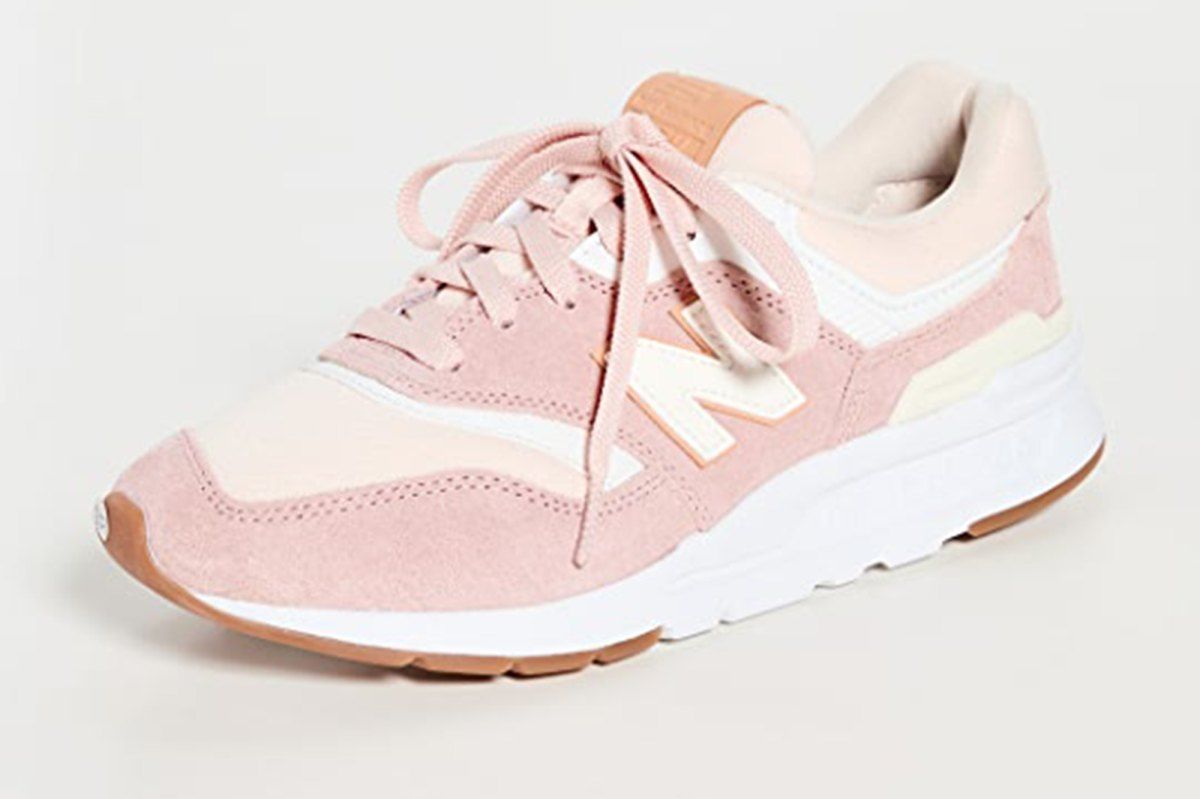 A pair of pink and white New Balance sneakers - New Balance