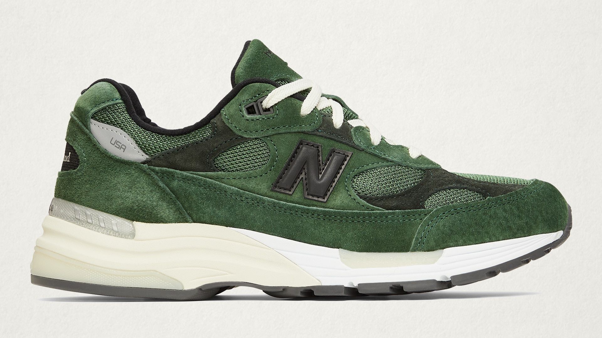 A pair of green New Balance 992 sneakers on a white background - New Balance