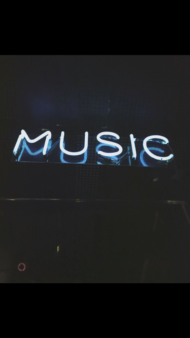 A neon sign that says music - Music