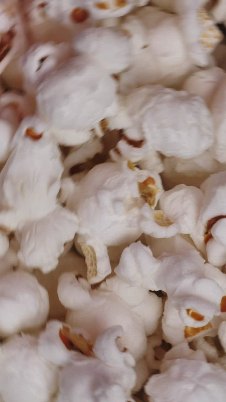 A close up of popcorn in a bowl, spinning. - Popcorn