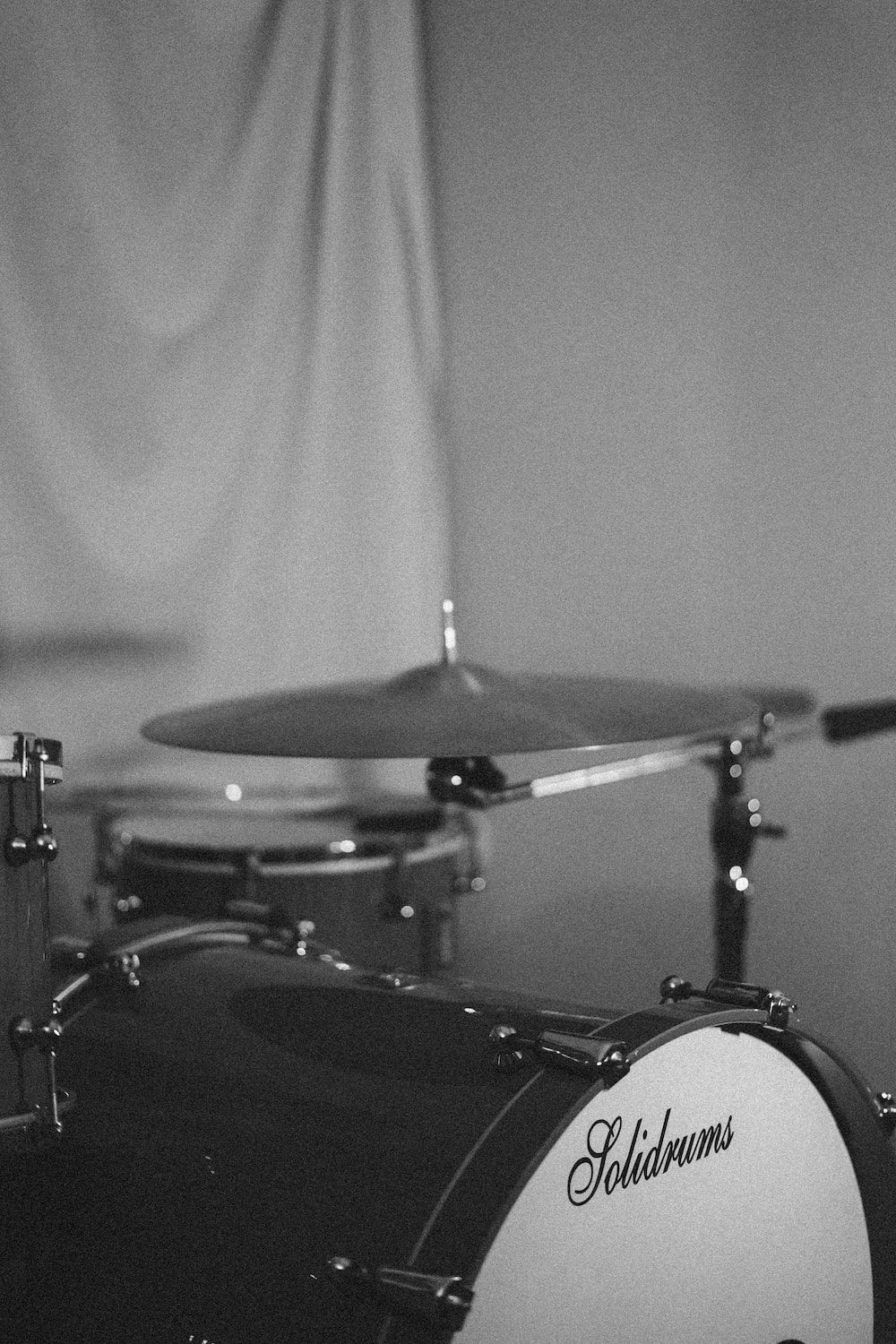 A black and white photo of a drum set. - Music