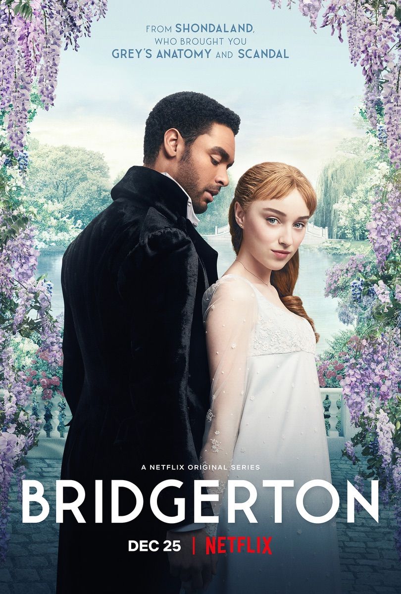 A man in a black suit and a woman in a white dress stand back to back in front of a garden with purple flowers. - Bridgerton