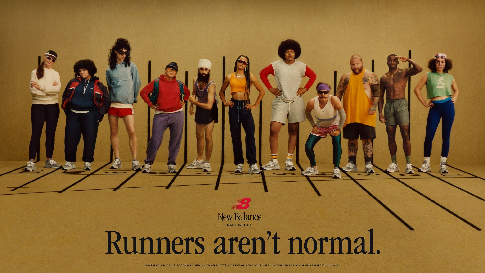 A group of people stand on a track in the new Balance ad. - New Balance
