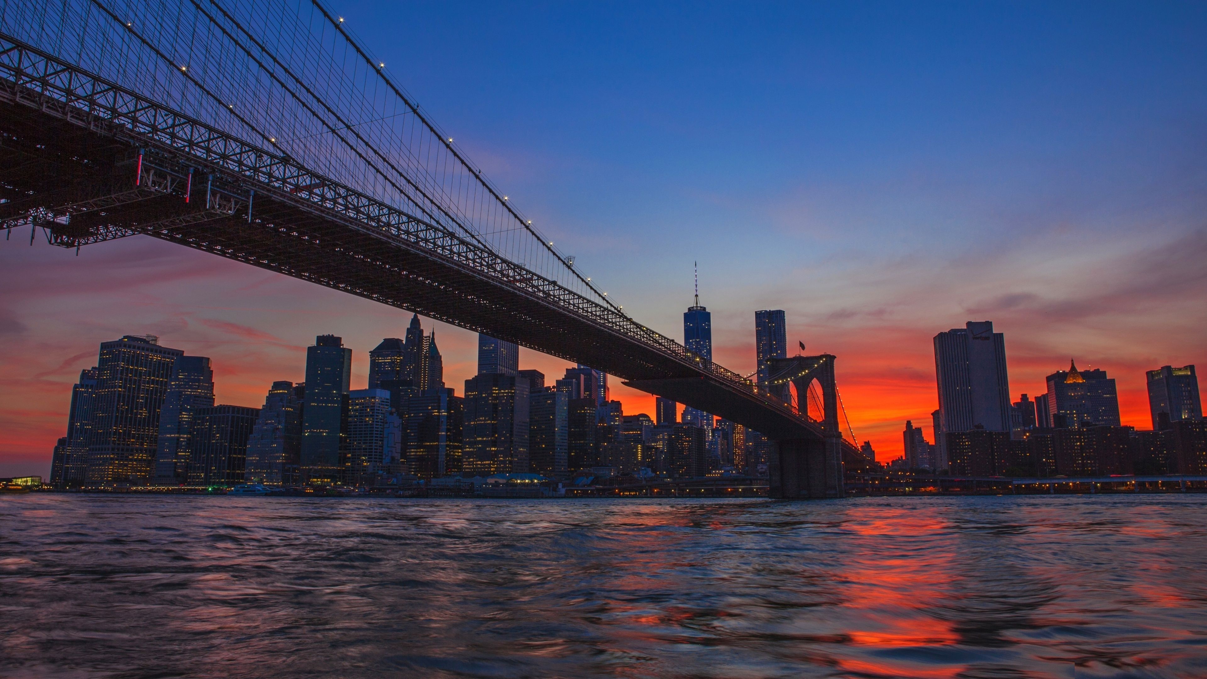 The Brooklyn Bridge spans the East River in New York City, connecting Brooklyn to Manhattan. - New York