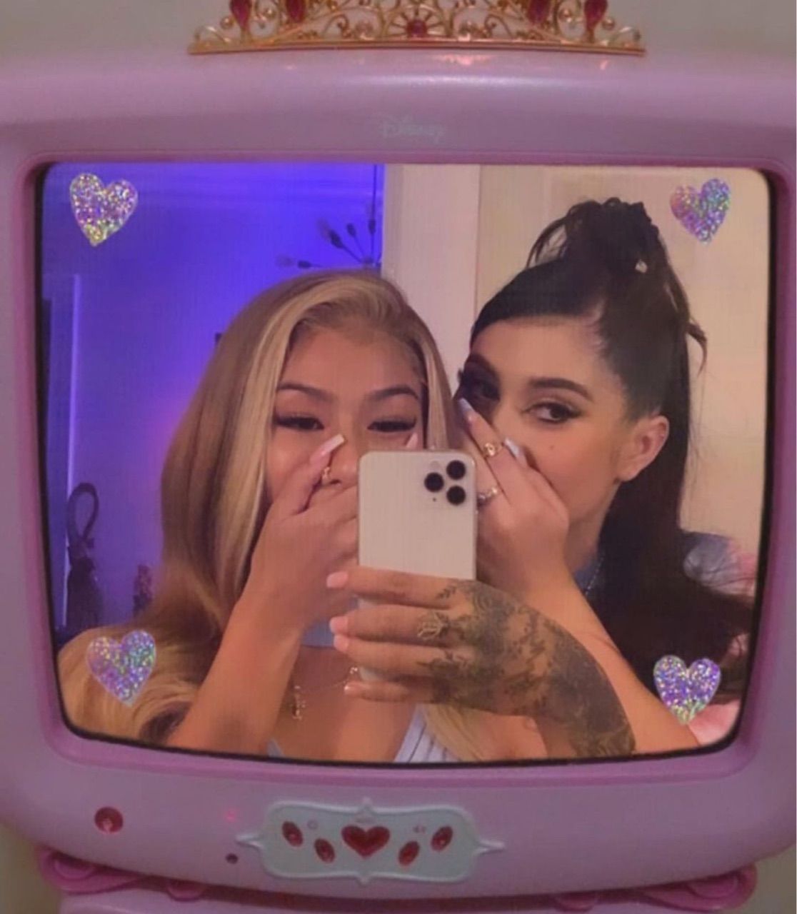 Two girls taking a selfie on a pink TV. - Kali Uchis