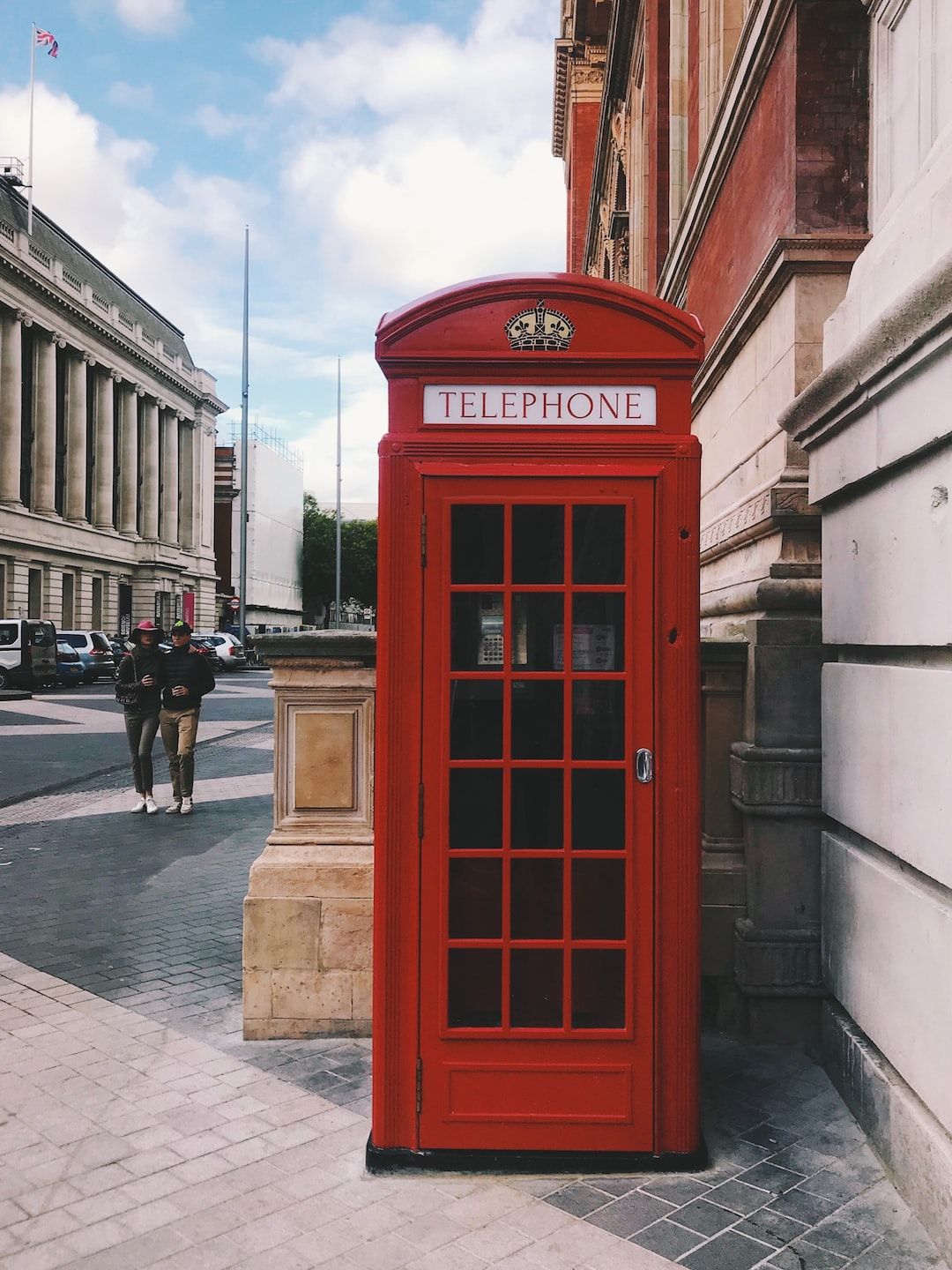 A red telephone box on a street corner - London