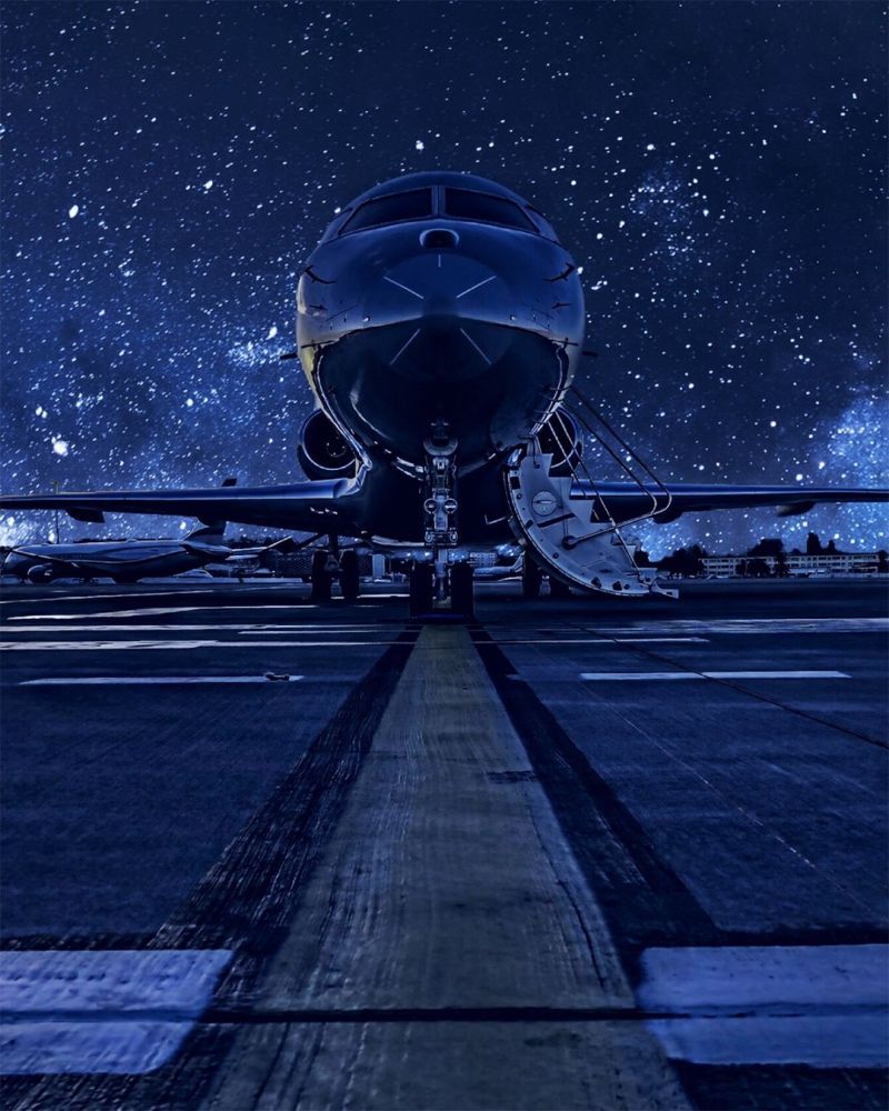 An airplane on the runway under a starry night sky - Airplane