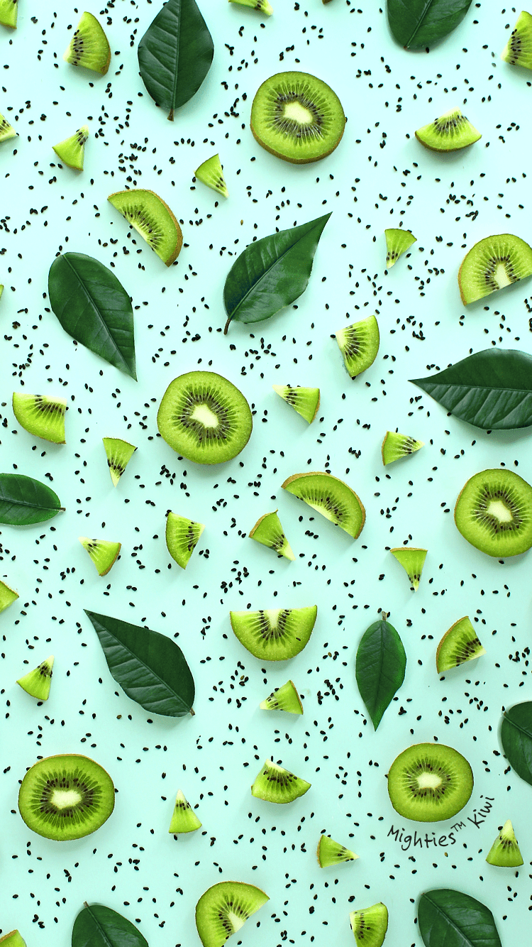 A pattern of kiwi slices and leaves on a green background. - Kiwi