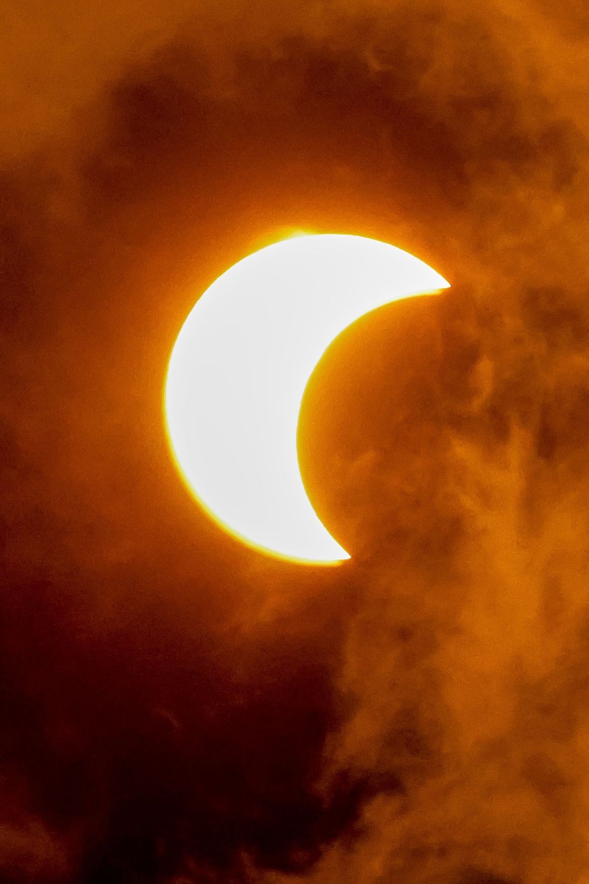 The moon partially covers the sun during a solar eclipse. - Eclipse