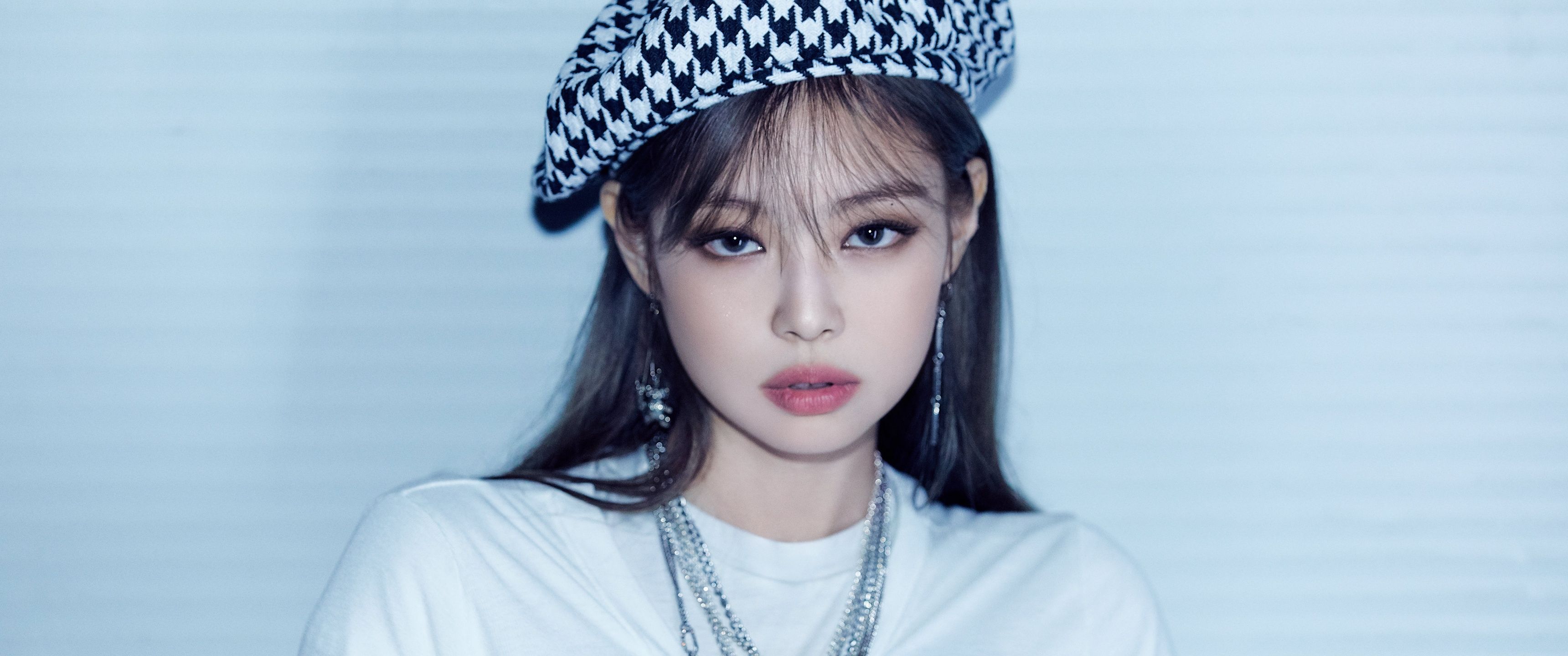 Lisa of Blackpink in a white top and a houndstooth cap - Jennie