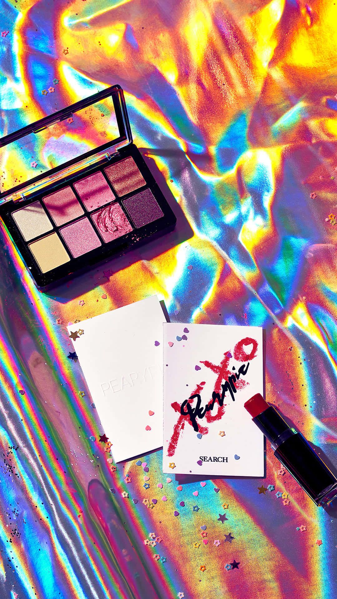 A palette, a lipstick and a card on a holographic background - Makeup