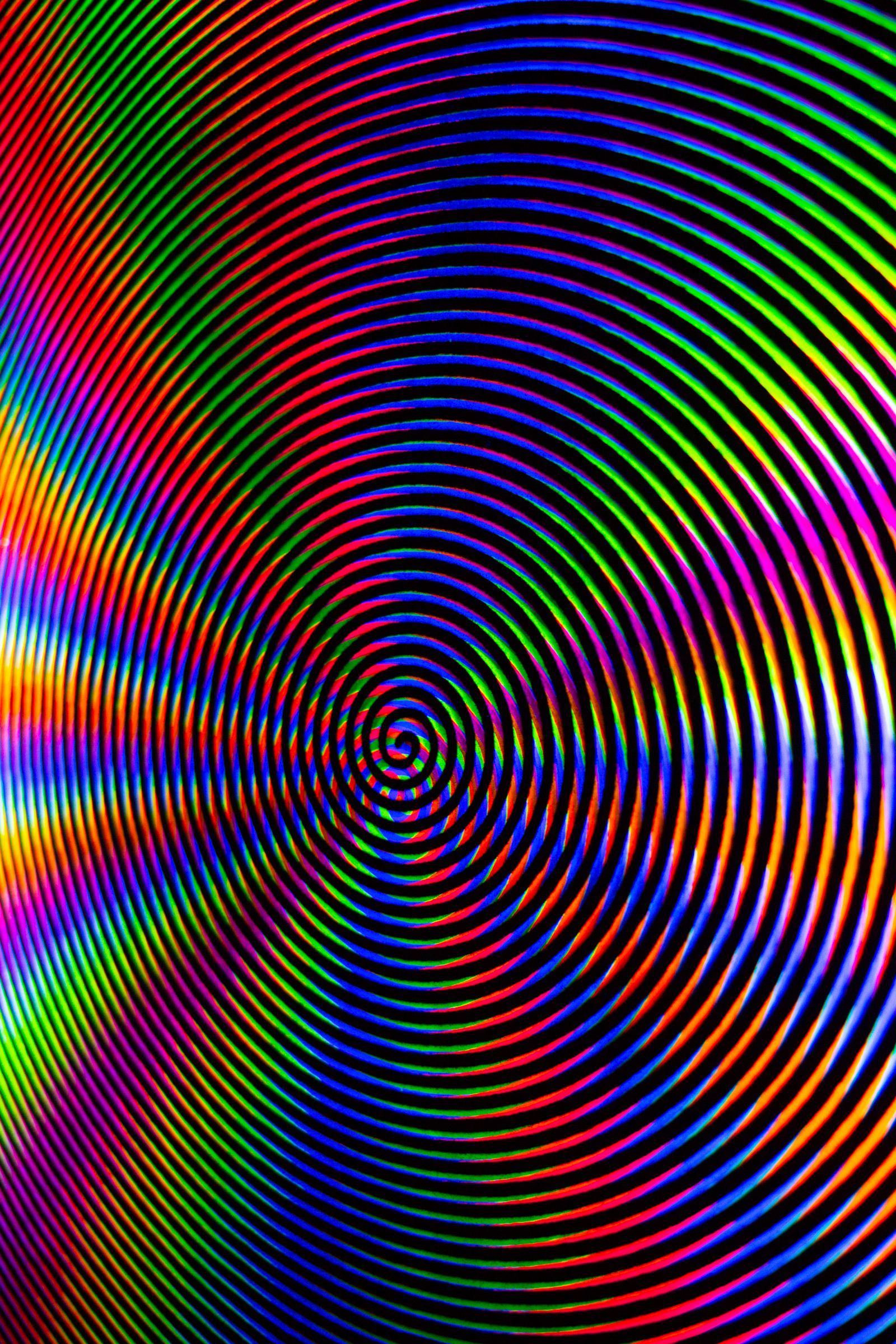 An abstract image of concentric circles in rainbow colors. - Trippy