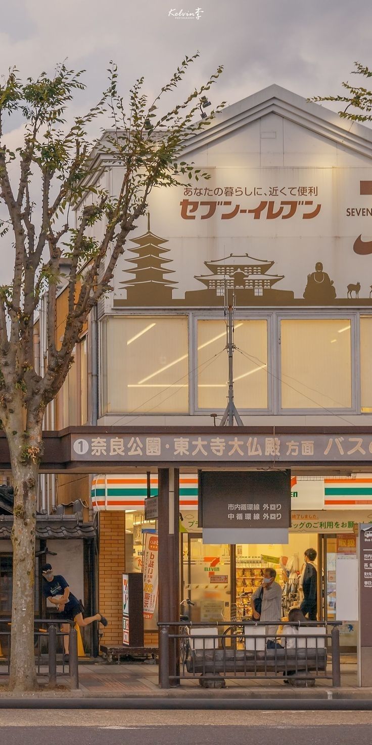 A convenience store in Japan with a bench in front of it - Japanese