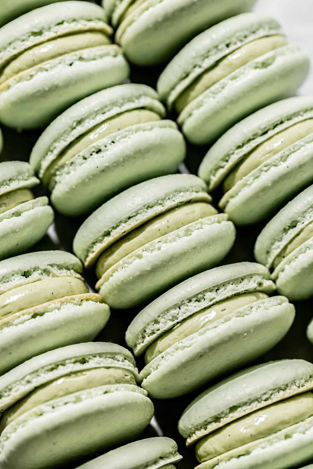 A close up of green matcha macarons with a green buttercream filling - Macarons