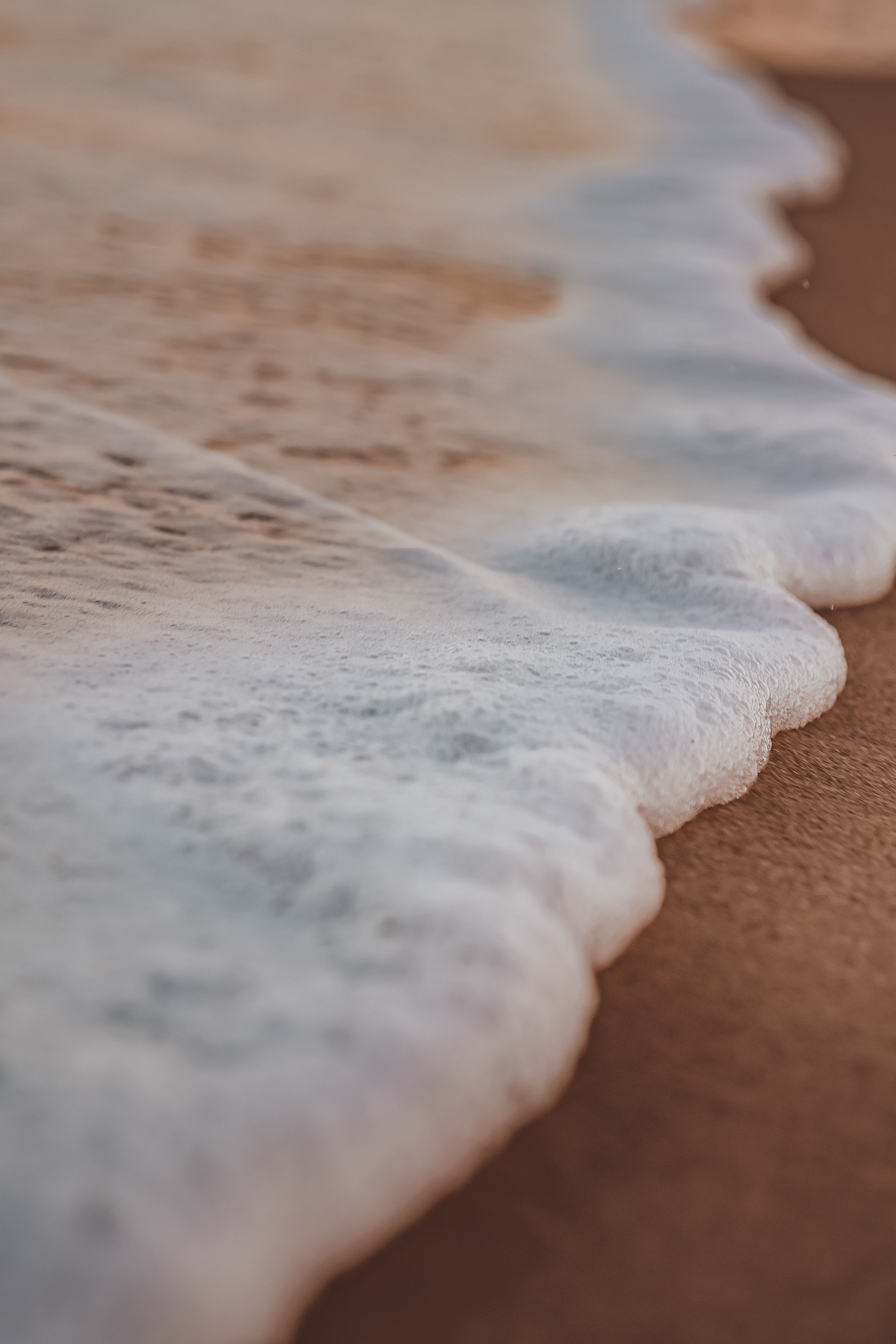 Close Up Photo Of Foamy Sea Wate On Sand · Free