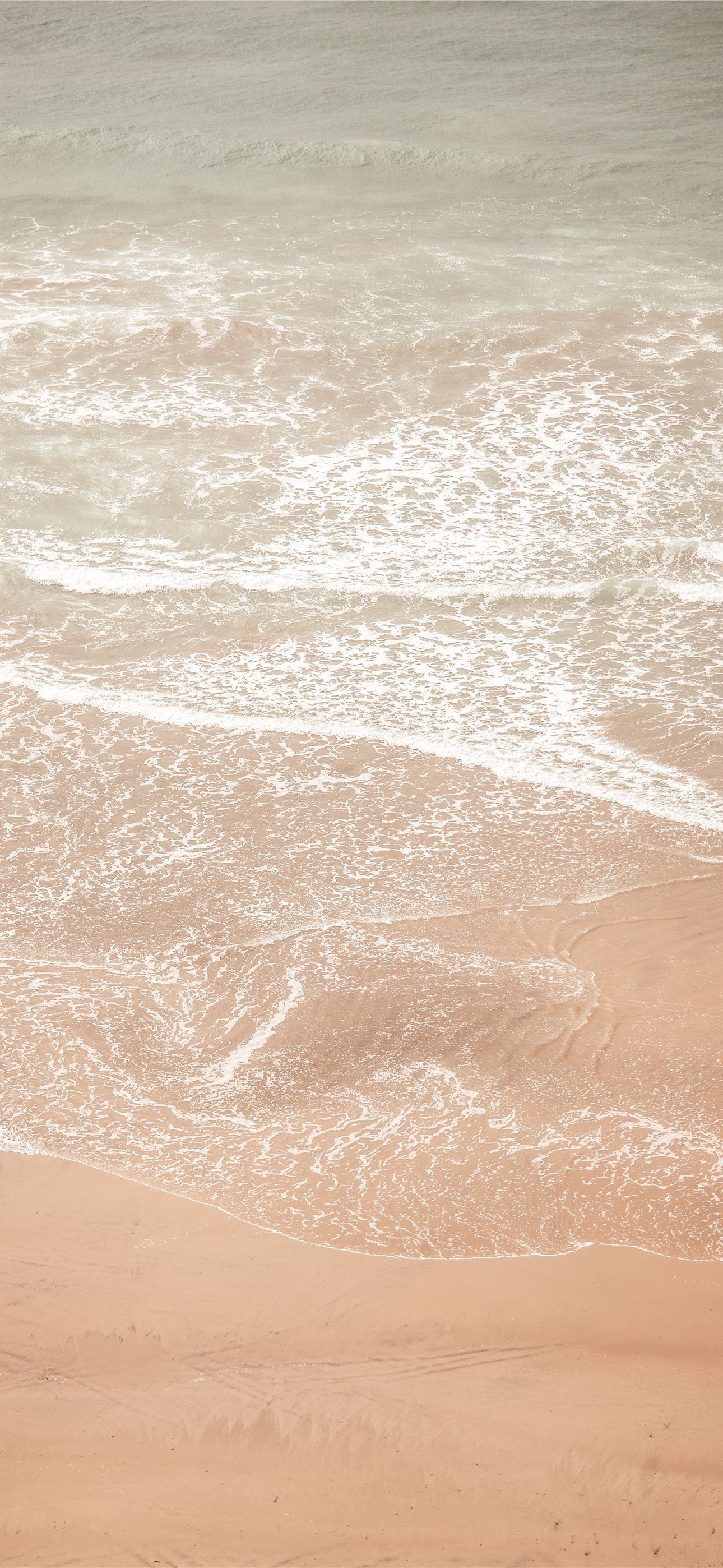 A beach with brown sand and body of water during daytime iPhone Wallpaper Free Download. - Sand