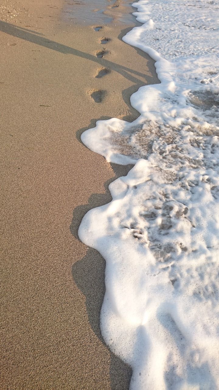 Footprints in the sand on a beach. - Sand