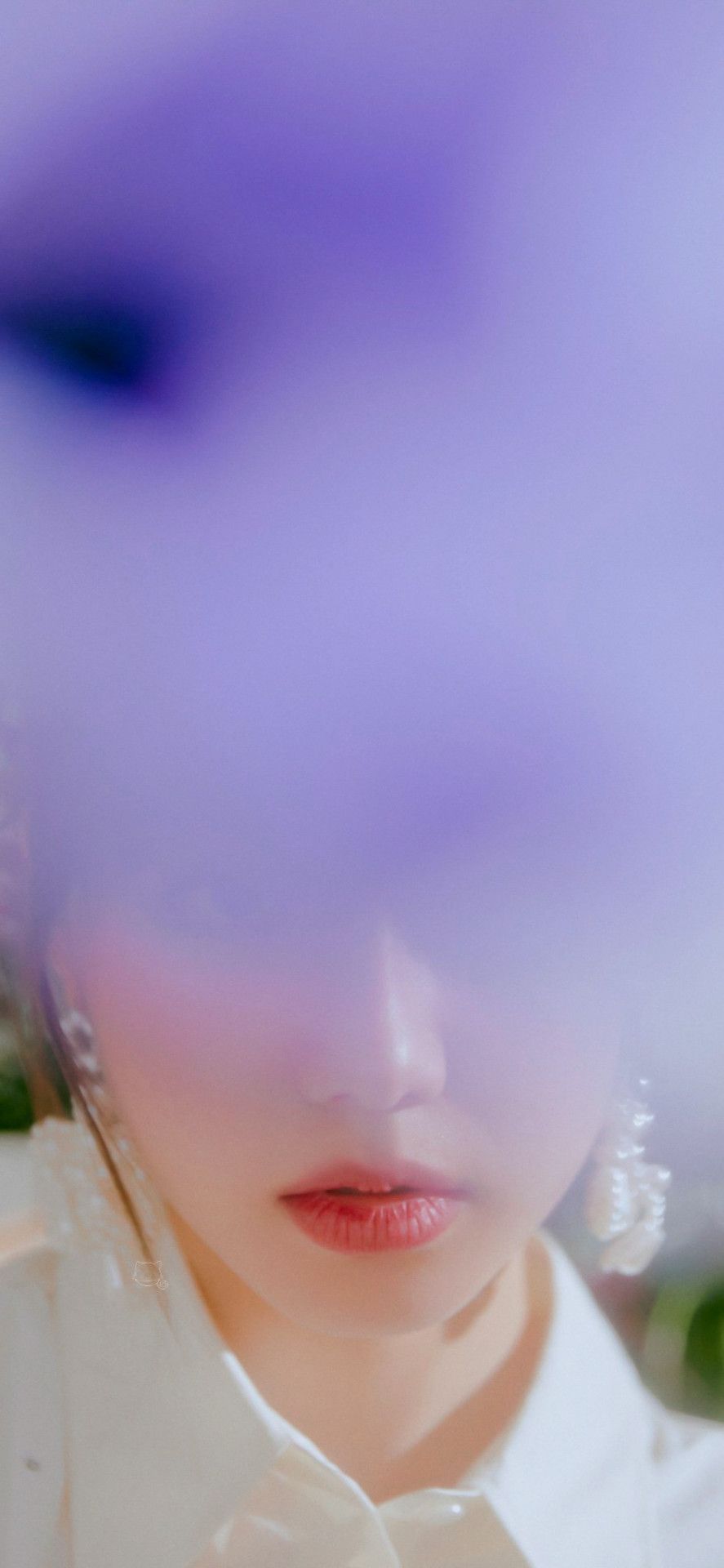 Close up of a woman's face with a purple filter - FIFTY FIFTY