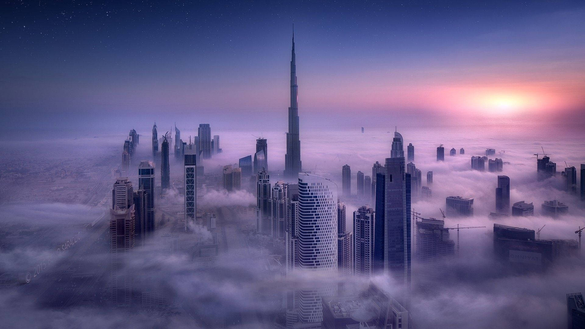 A cityscape of skyscrapers with a purple sky - Dubai