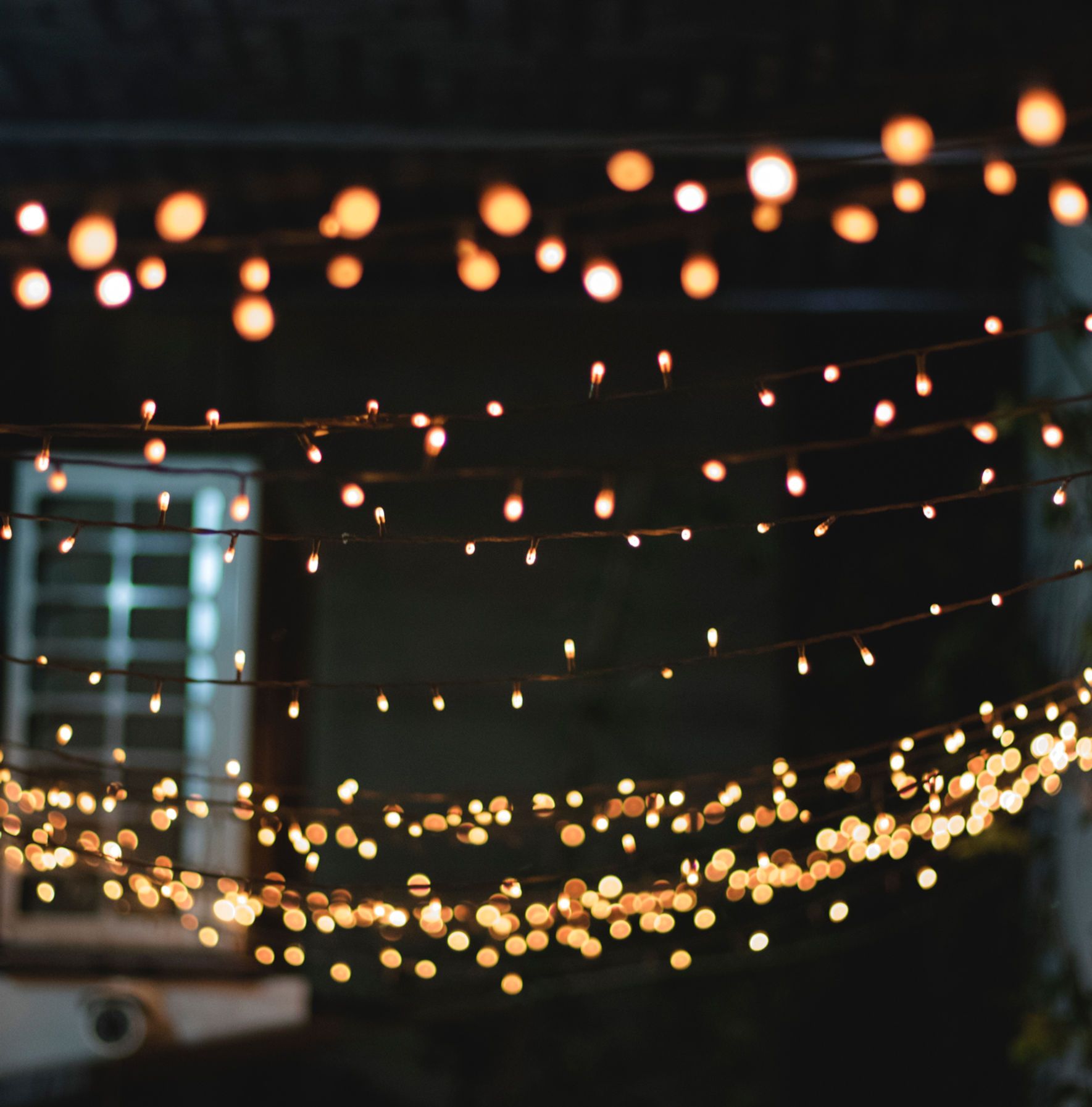 A string of lights hanging from a ceiling. - Fairy lights