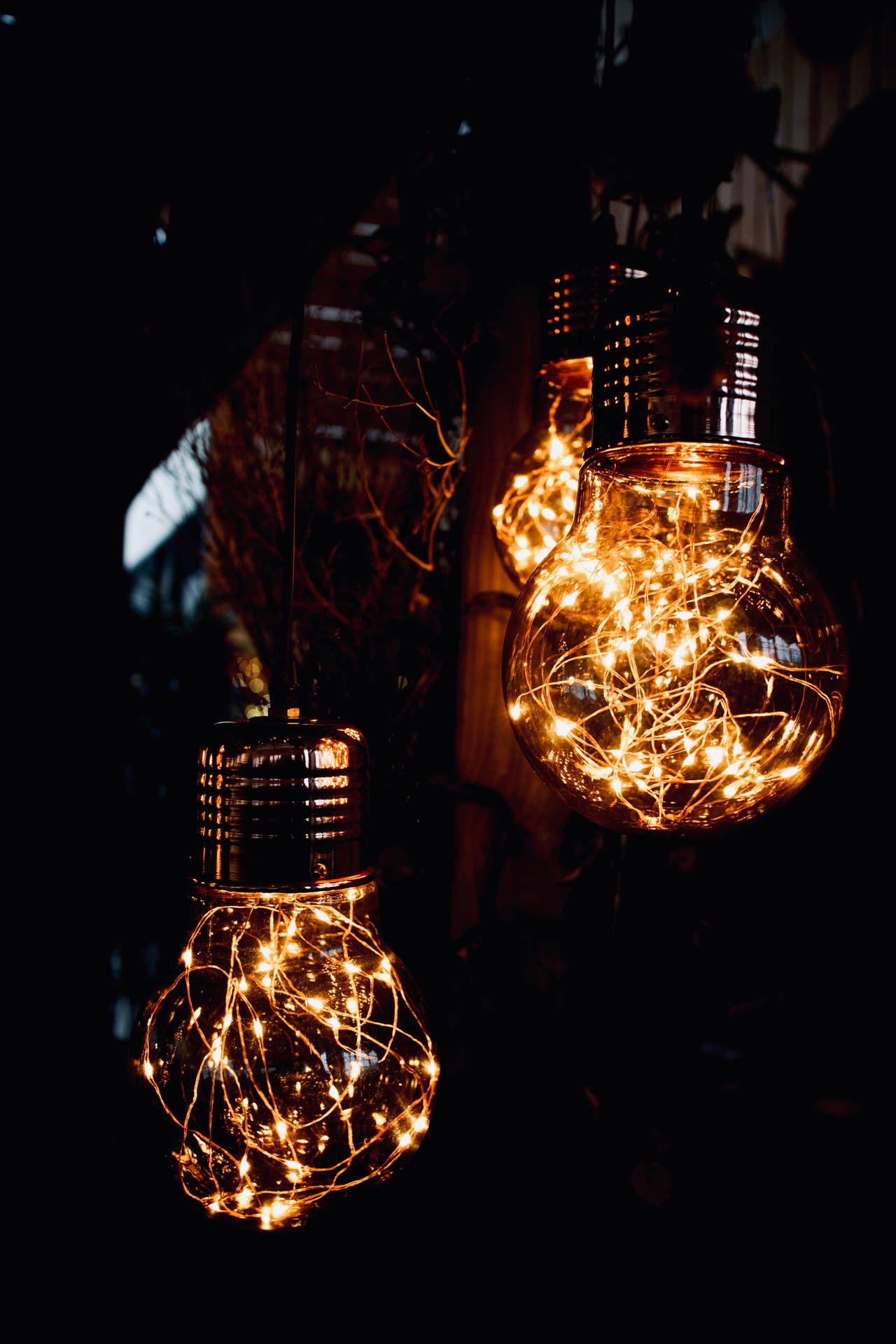Three light bulbs hanging in the dark. - Fairy lights