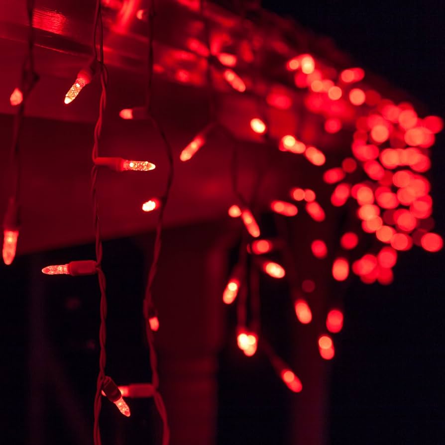 Red LED Icicle Lights hanging from a roof - Fairy lights