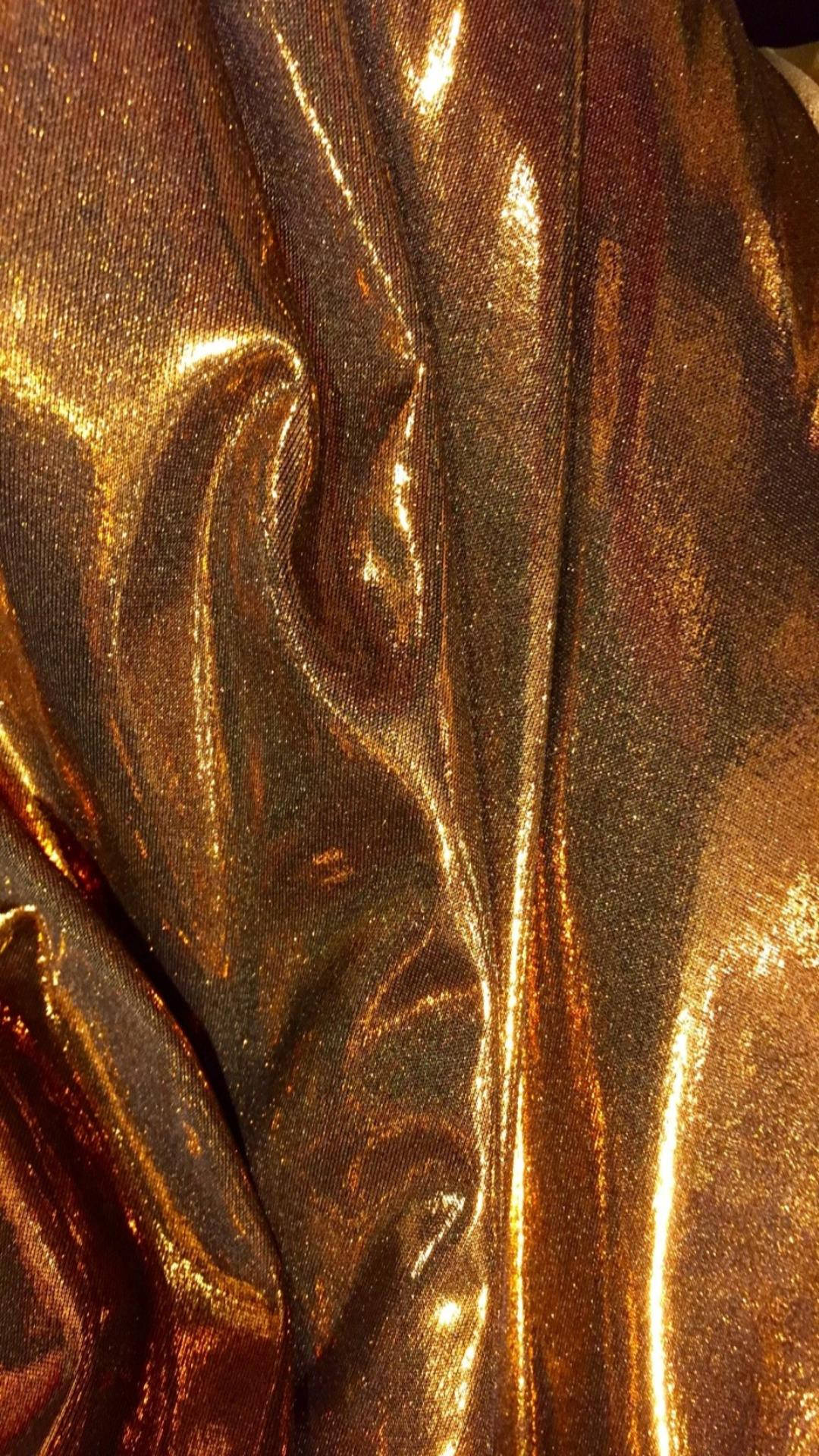 A close up of some gold and silver fabric - Gold