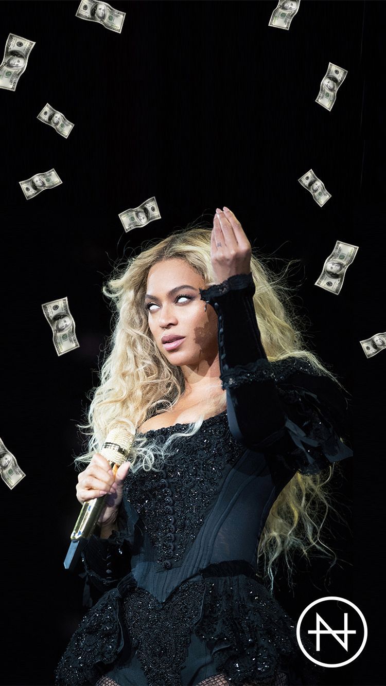 A woman singing with money falling around her - Beyonce