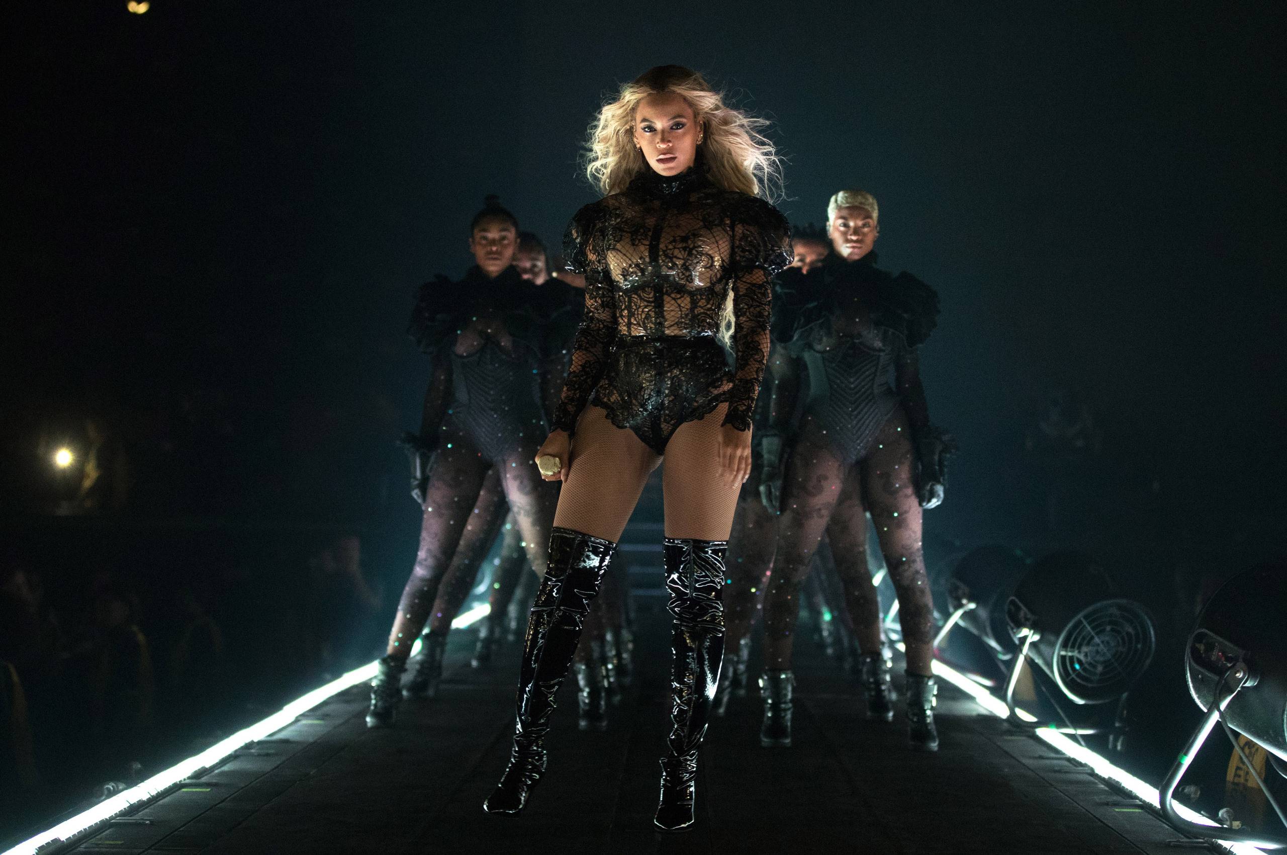 A woman in black leather boots walking down the runway - Beyonce