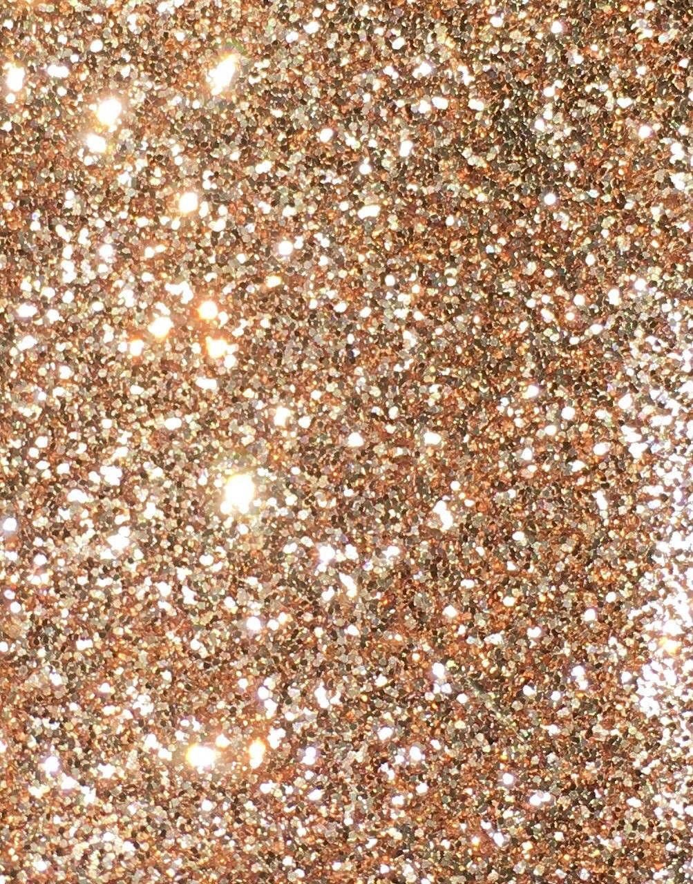 A close up of gold glitter on the ground - Gold, glitter