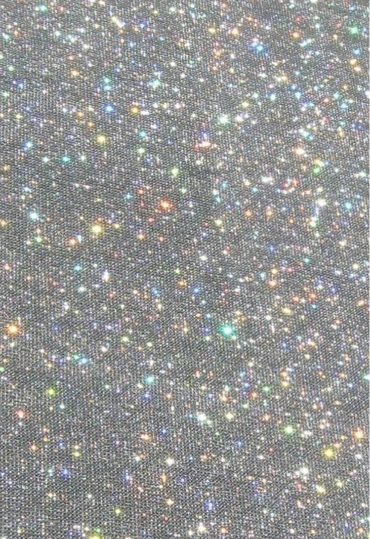 A close up of the fabric with stars on it - Glitter