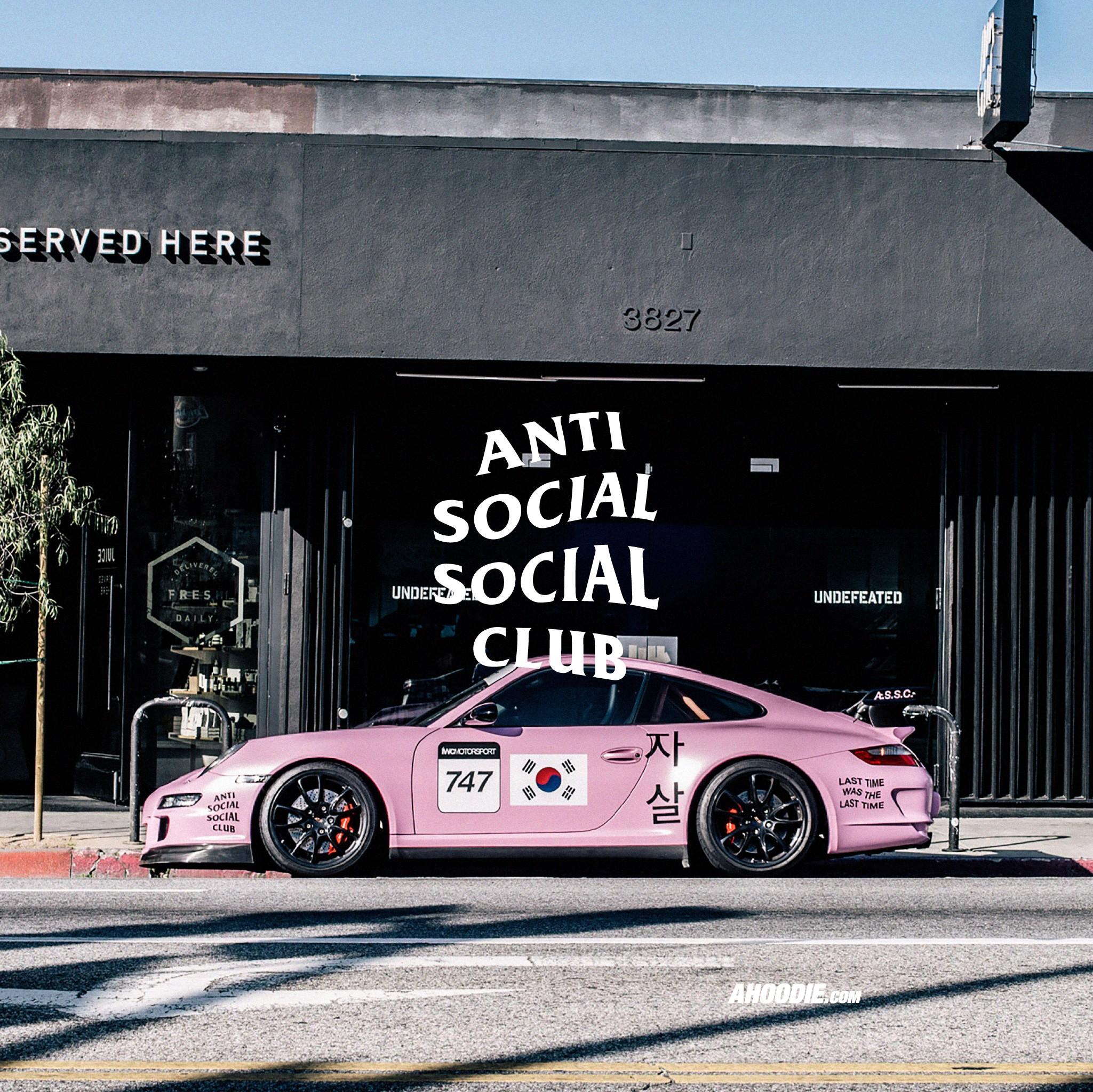 A pink car with Anti Social Social Club written on the wall behind it - Anti Social Social Club