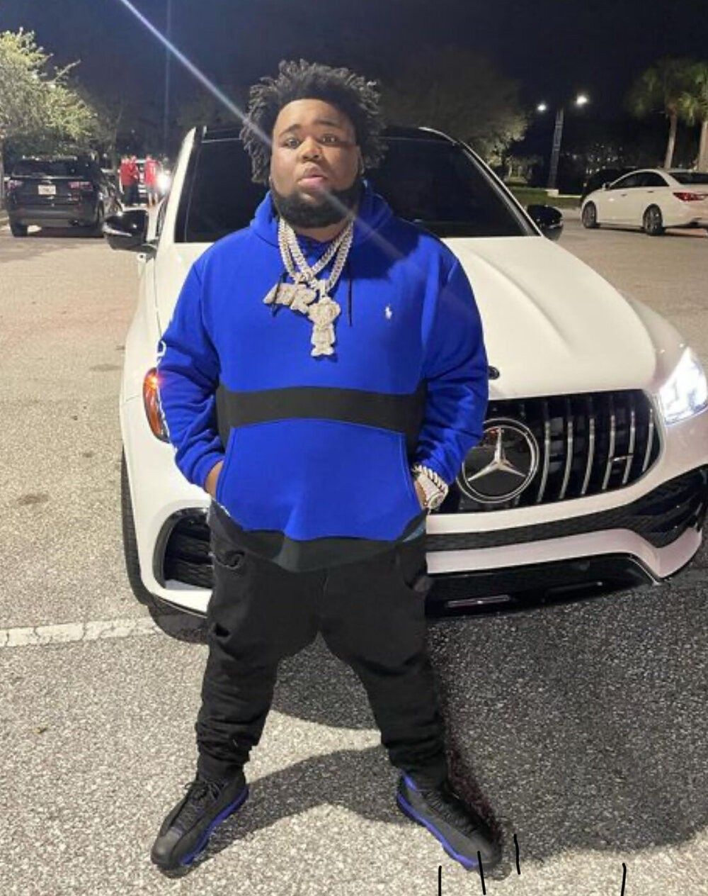 Rapper KJ Balla poses in front of a Mercedes Benz. Balla was shot and killed on May 15, 2021. - Rod Wave