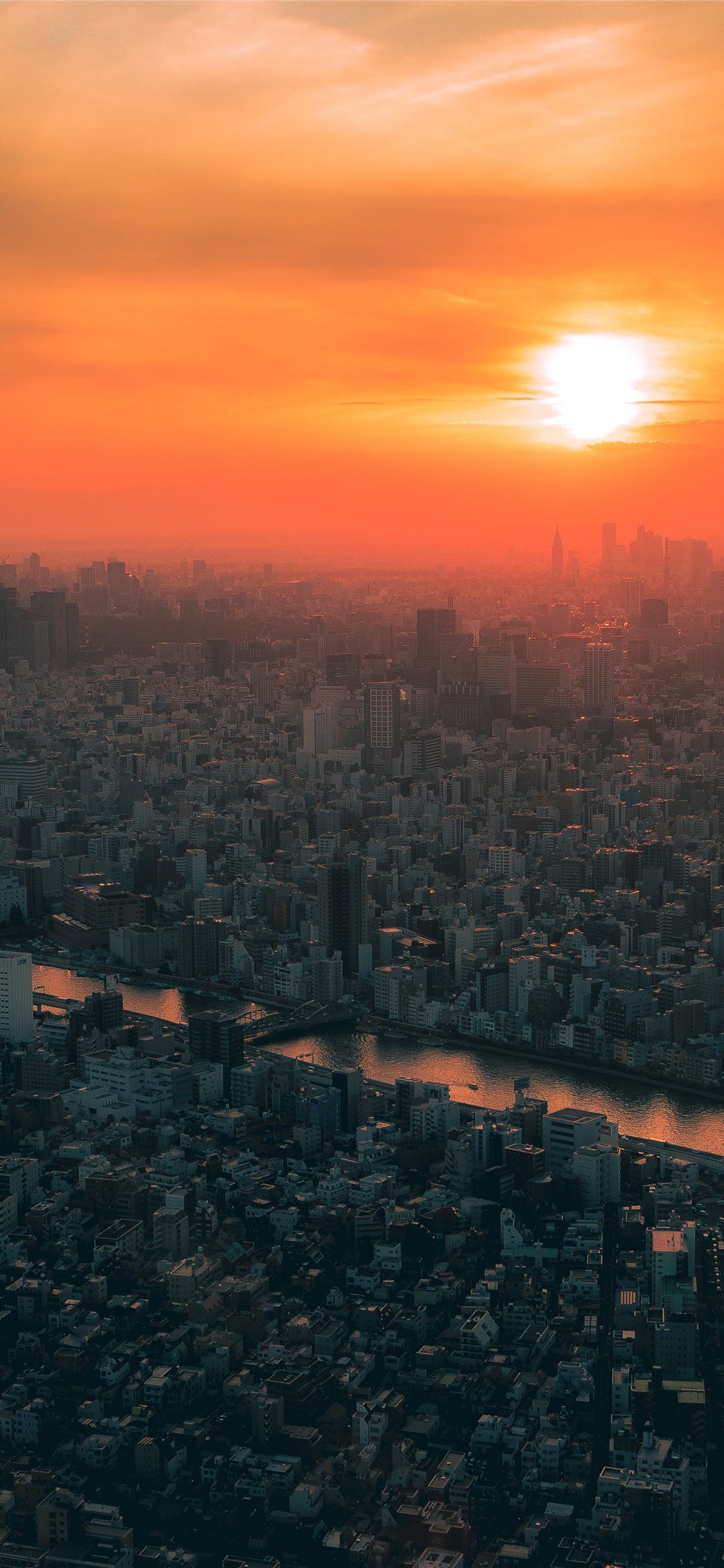 Cityscape at sunset, with orange and red hues in the sky - Tokyo, city