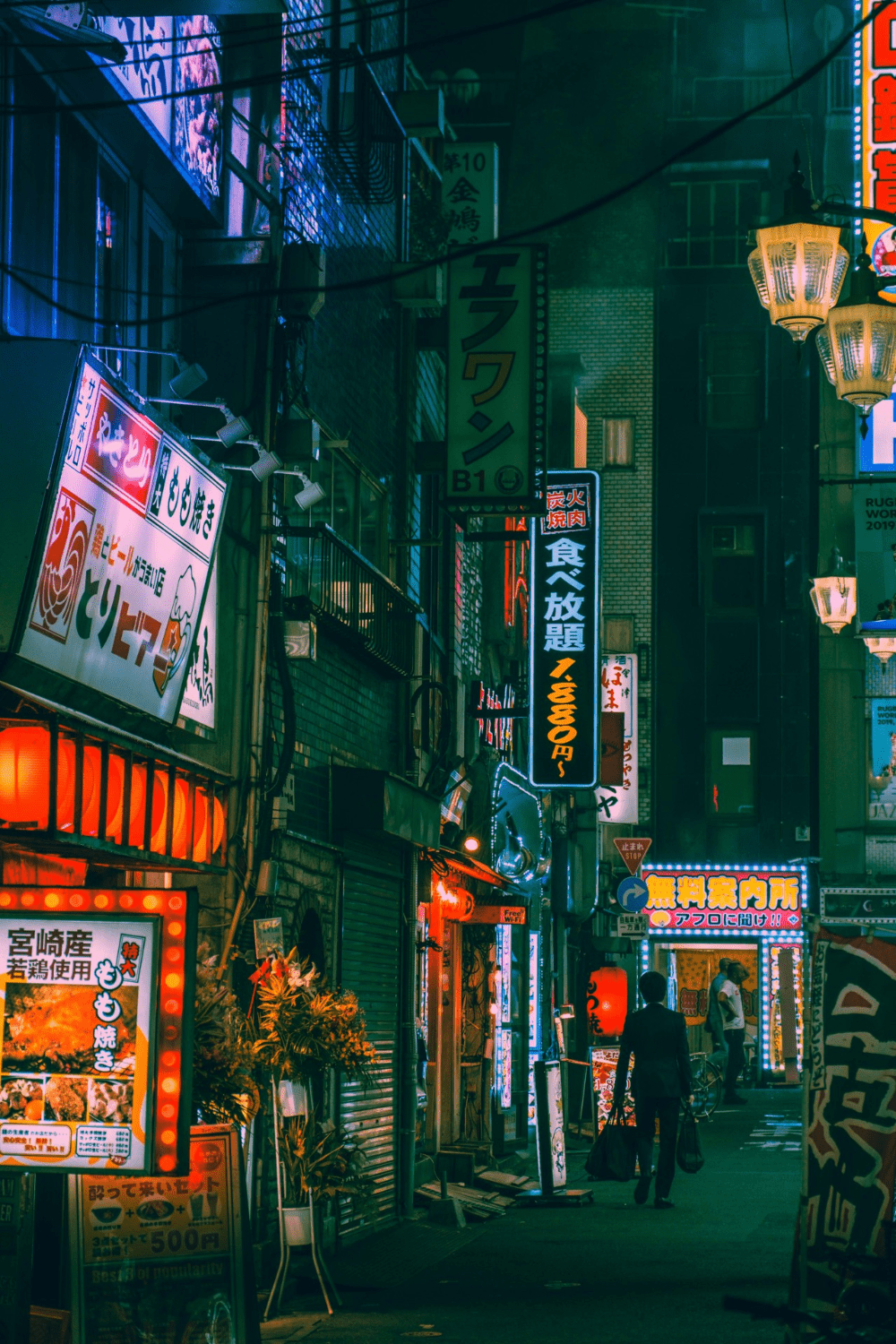A street with many neon lights and signs - Tokyo