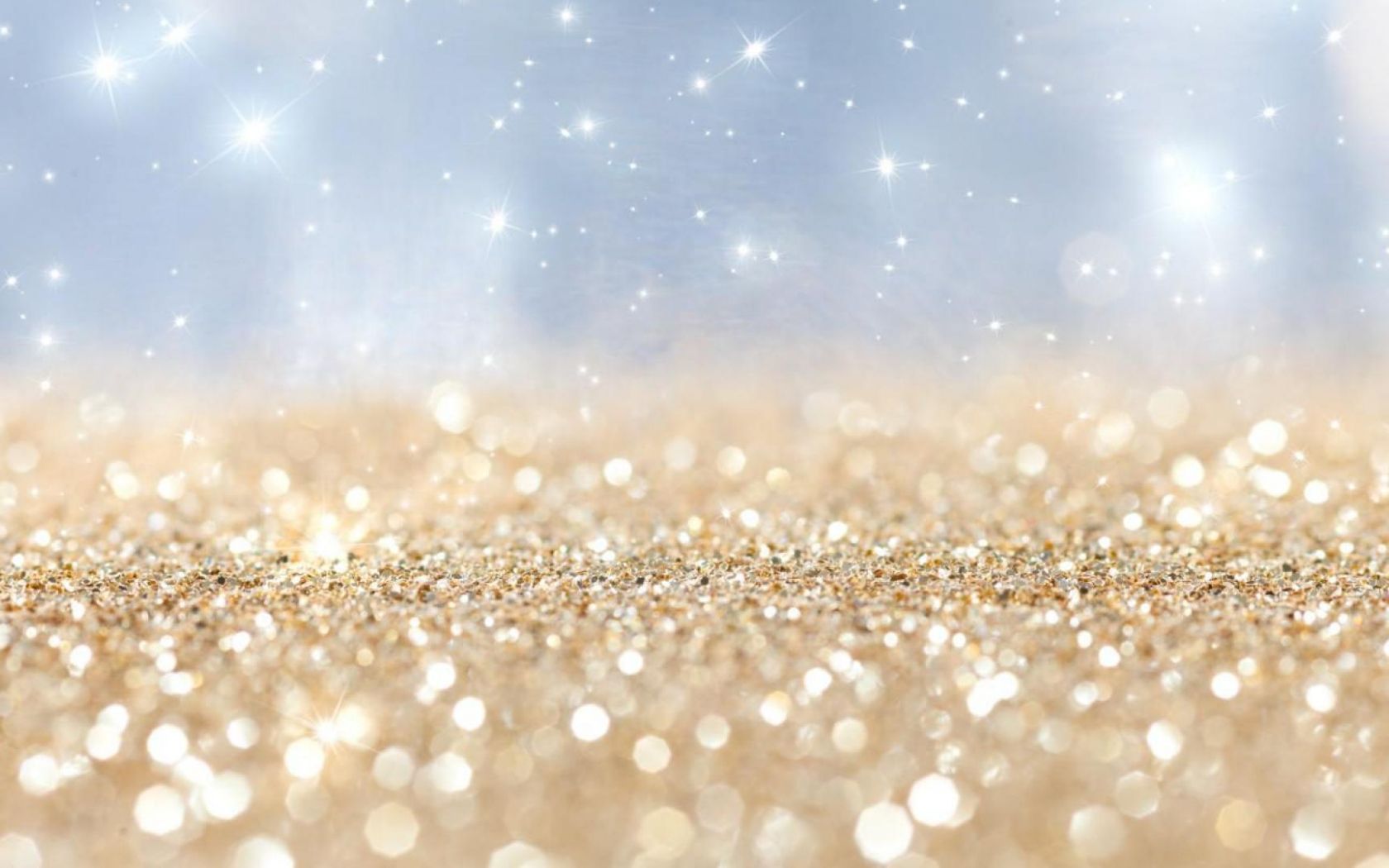 A close up of a golden glittery surface with a blue background - Glitter