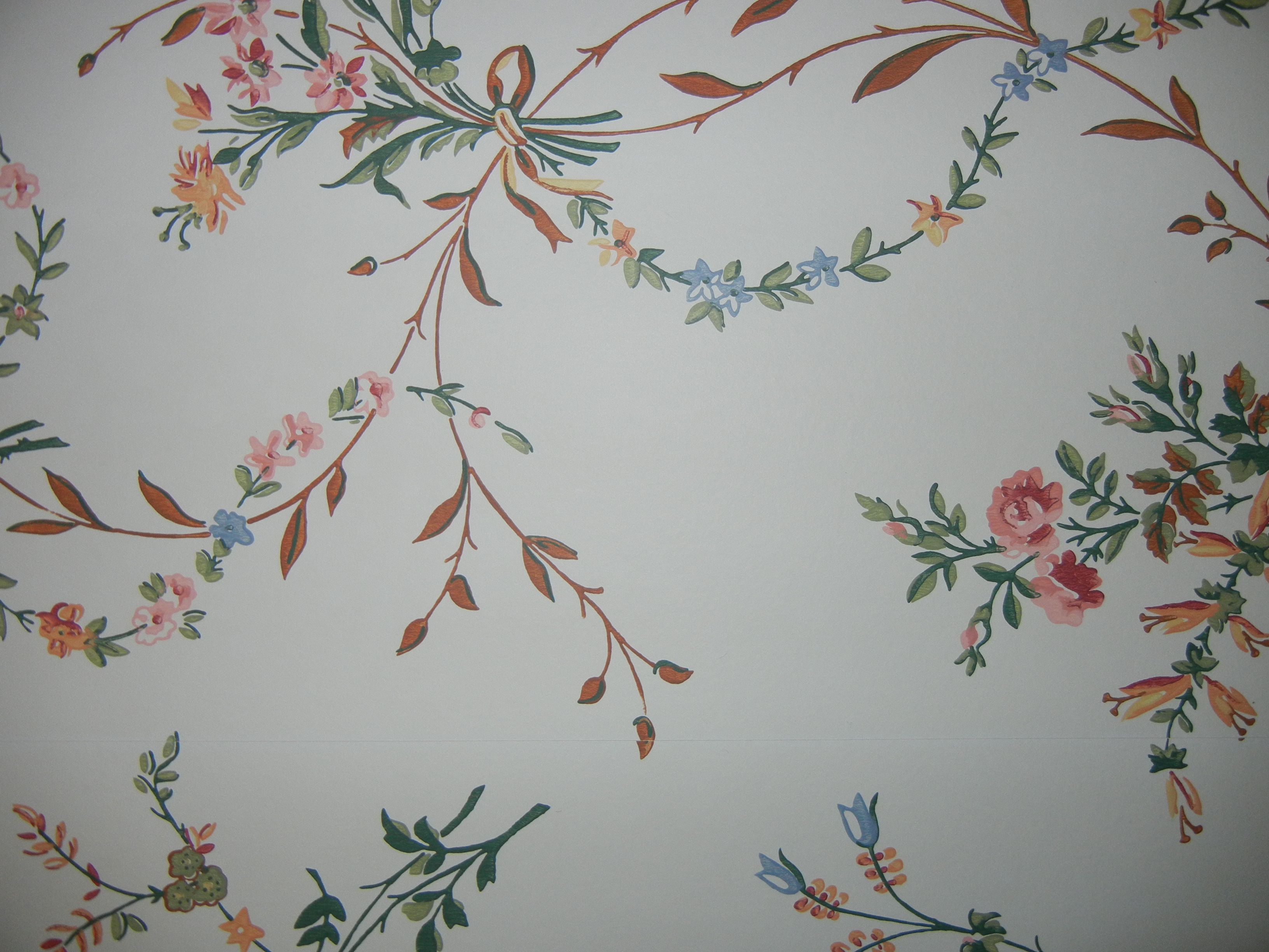 A white wall with a floral pattern of flowers and leaves painted on it. - Victorian