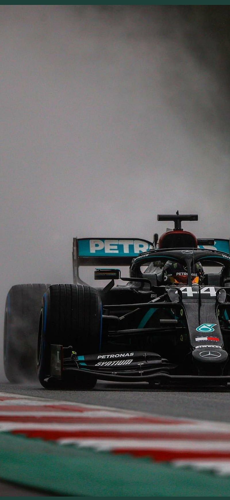 Lewis Hamilton driving his car on a track with a cloud in the sky. - Lewis Hamilton