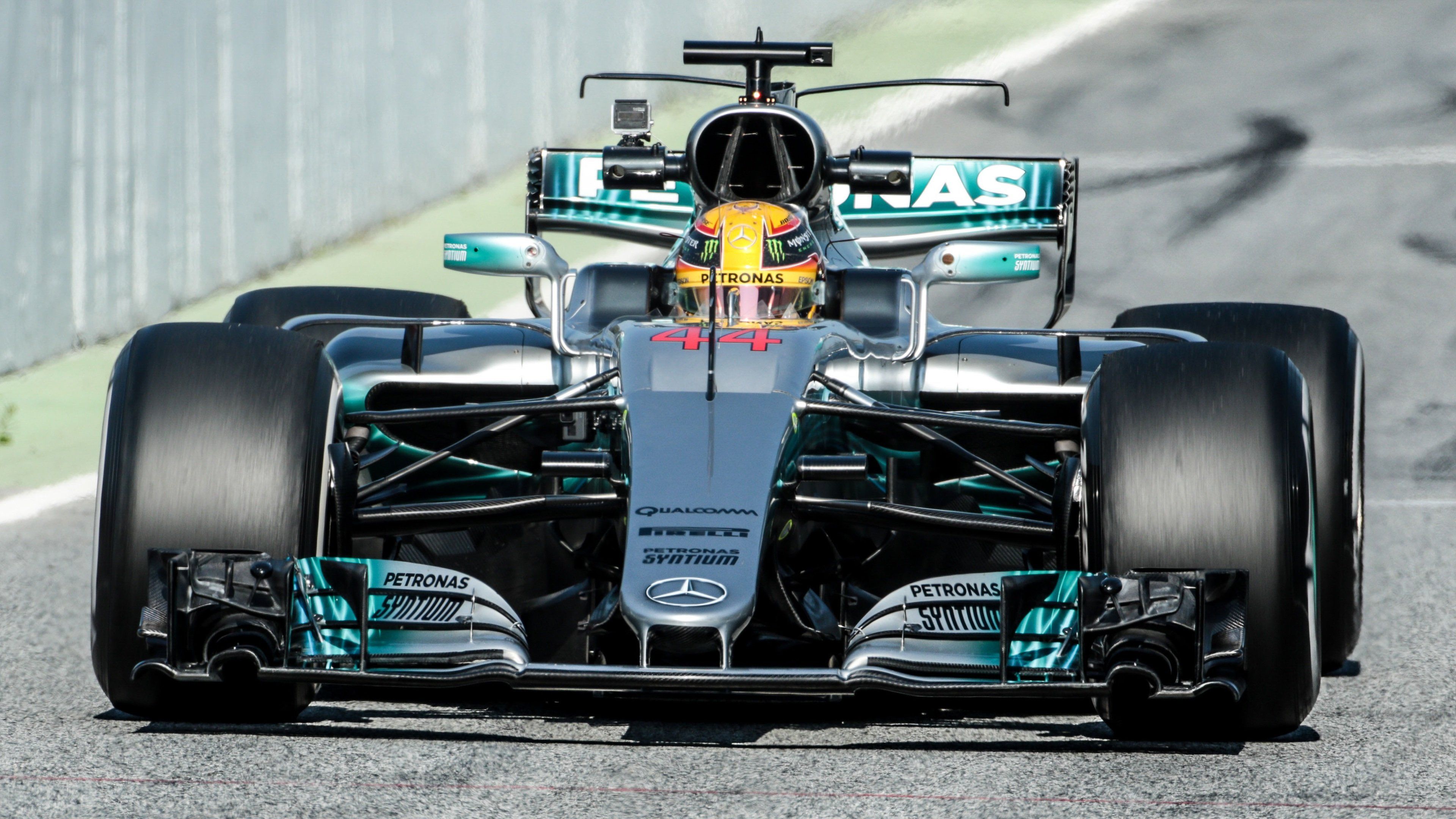 The Mercedes Formula 1 car is shown in motion on the track. - Lewis Hamilton