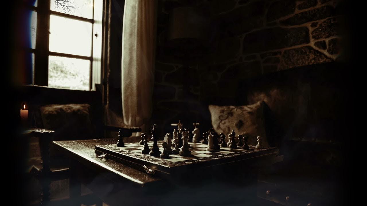 A chess board sits in the dark with a window in the background. - Chess