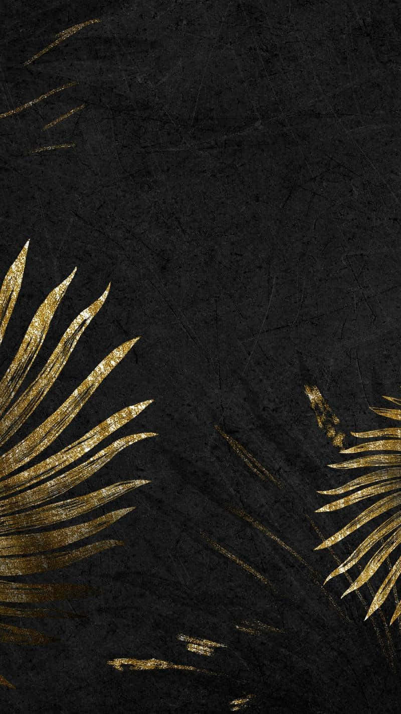 A gold leaf design on black background - Tropical, gold